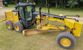 Motor grader grading road